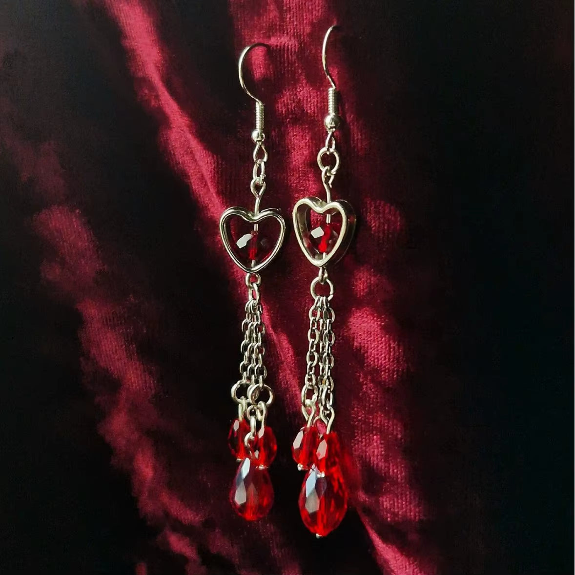 Pendientes góticos de vampiro con corazón y pedrería roja sangrienta, disponibles con corazón simple o atravesado por puñal, joyería dark.
Esta imagen muestra la version con el corazón simple.
